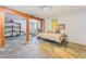 Spacious bedroom featuring stone floors, a comfortable bed, and wooden support beams at 2532 Arrowhead St, North Las Vegas, NV 89030