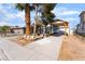 Charming single-story home with a long covered driveway and desert landscaping in front at 2532 Arrowhead St, North Las Vegas, NV 89030