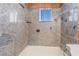 This shower features stone walls and a stone shelf for toiletries at 2532 Arrowhead St, North Las Vegas, NV 89030