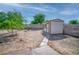 A backyard featuring a shed, mature trees, and a block wall providing privacy at 2880 Placita Ct, Las Vegas, NV 89121