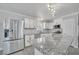 Modern kitchen with stainless steel appliances, white cabinetry, and granite countertops at 2880 Placita Ct, Las Vegas, NV 89121