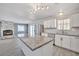 Bright kitchen with island, stainless steel appliances, and an adjacent living area with a fireplace at 2880 Placita Ct, Las Vegas, NV 89121