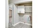 Small laundry room includes built in cabinet and shelving at 2880 Placita Ct, Las Vegas, NV 89121