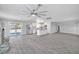 Spacious living area boasting tile floors, kitchen access, and a modern ceiling fan at 2880 Placita Ct, Las Vegas, NV 89121