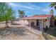 A shaded patio with seating. View of fenced in backyard with shade trees at 2880 Placita Ct, Las Vegas, NV 89121