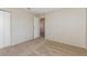 Carpeted bedroom with closet and open access to the hallway and staircase at 2924 Pleasant Lake Dr, Las Vegas, NV 89117