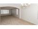 Spacious dining room with neutral walls, plush carpeting, and arched doorways at 2924 Pleasant Lake Dr, Las Vegas, NV 89117