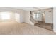 Open-concept living area with plush carpet and wood-look floors leading to the staircase at 2924 Pleasant Lake Dr, Las Vegas, NV 89117