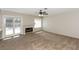Cozy living room featuring plush carpeting, a ceiling fan, and a classic fireplace at 2924 Pleasant Lake Dr, Las Vegas, NV 89117