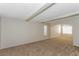 Spacious living room featuring plush carpeting, a ceiling fan, and arched doorways at 2924 Pleasant Lake Dr, Las Vegas, NV 89117