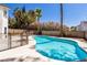 Backyard pool with lush greenery, landscaping, and a secure safety fence at 2924 Pleasant Lake Dr, Las Vegas, NV 89117