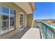 Balcony overlooking neighborhood, mountains in distance, and green walking space with palm trees at 30 Strada Di Villaggio # 441, Henderson, NV 89011