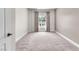 Bright carpeted bedroom with neutral walls boasts a large window with curtains and lots of sunlight at 30 Strada Di Villaggio # 441, Henderson, NV 89011