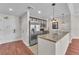Modern kitchen featuring stainless steel appliances and a breakfast bar with granite countertops at 30 Strada Di Villaggio # 441, Henderson, NV 89011