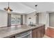 Open concept kitchen with stainless steel appliances and granite countertop bar with sink at 30 Strada Di Villaggio # 441, Henderson, NV 89011