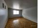 Bright bedroom with wood floors, white walls, and a window offering ample natural light at 3112 Piedmont Ave, Las Vegas, NV 89102