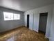 Bedroom with a large window and parquet floors featuring sliding door closets at 3112 Piedmont Ave, Las Vegas, NV 89102
