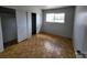 Bedroom featuring light parquet floors, closet, and a large window offering natural light at 3112 Piedmont Ave, Las Vegas, NV 89102