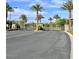 Exterior of community featuring a gated entry with multiple palm trees in the area at 3114 Molinos Dr, Las Vegas, NV 89141