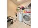 Laundry room with tile floors, a washer and dryer, storage and shelves for laundry accessories at 3114 Molinos Dr, Las Vegas, NV 89141