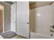 Bright bathroom features a shower-tub combo and neutral tile flooring at 32 E Serene Ave # 207, Las Vegas, NV 89123