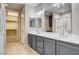 Bathroom featuring tiled floors, double vanity, shower stall, and walk in closet access at 32 E Serene Ave # 207, Las Vegas, NV 89123