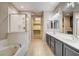 Bathroom featuring tiled floors, double vanity, soaking tub, and shower stall at 32 E Serene Ave # 207, Las Vegas, NV 89123