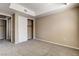 Bright bedroom featuring neutral carpeting, closet, and ensuite bathroom access at 32 E Serene Ave # 207, Las Vegas, NV 89123