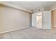 Bright bedroom featuring neutral walls and carpeting and ensuite bathroom access at 32 E Serene Ave # 207, Las Vegas, NV 89123