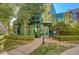 Modern glass condo building entrance with manicured green lawn and walkway at 32 E Serene Ave # 207, Las Vegas, NV 89123