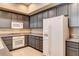 Bright corner kitchen with white appliances, granite counters and tiled floor at 32 E Serene Ave # 207, Las Vegas, NV 89123