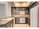 Galley kitchen features granite countertops and white appliances at 32 E Serene Ave # 207, Las Vegas, NV 89123