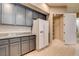 A kitchen featuring granite countertops, gray cabinetry, and a pantry for ample storage space at 32 E Serene Ave # 207, Las Vegas, NV 89123
