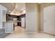 Bright kitchen with granite counters, grey cabinets, and tile flooring adjacent to the entry at 32 E Serene Ave # 207, Las Vegas, NV 89123