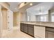 An open kitchen design with granite countertops, stainless steel appliances, and a breakfast bar at 32 E Serene Ave # 207, Las Vegas, NV 89123
