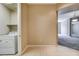 Convenient laundry area adjacent to entryway, includes shelving at 32 E Serene Ave # 207, Las Vegas, NV 89123