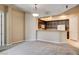 An open living space with a breakfast bar connecting the kitchen to the living room at 32 E Serene Ave # 207, Las Vegas, NV 89123