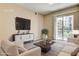 Bright living room with sliding glass doors to balcony and comfortable seating area at 32 E Serene Ave # 207, Las Vegas, NV 89123