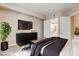 Comfortable main bedroom featuring a TV, large dresser and ensuite bathroom access at 32 E Serene Ave # 207, Las Vegas, NV 89123