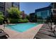 Refreshing swimming pool with lounge chairs at a modern condo complex at 32 E Serene Ave # 207, Las Vegas, NV 89123