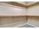 Walk-in Closet featuring open shelving, neutral carpeting, and ample storage space at 32 E Serene Ave # 207, Las Vegas, NV 89123