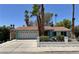 Charming single-story home with a well-manicured lawn, mature palm trees, and a two-car garage at 349 Esquina Dr, Henderson, NV 89014