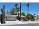 Traditional single-story home with mature palm trees, a two-car garage, and a well-kept lawn at 349 Esquina Dr, Henderson, NV 89014