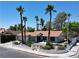 Attractive single-story home with mature palm trees, a two-car garage, and a well-manicured lawn at 349 Esquina Dr, Henderson, NV 89014
