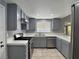 Kitchen with stainless steel appliances, tile countertops, and grey cabinets at 349 Esquina Dr, Henderson, NV 89014