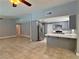 Open-concept living room and kitchen with tile flooring and stainless steel appliances at 349 Esquina Dr, Henderson, NV 89014