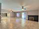 Open-concept living room with tile floors, fireplace, and sliding glass doors to the backyard pool at 349 Esquina Dr, Henderson, NV 89014