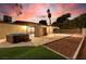 Backyard featuring a private hot tub, outdoor seating, artificial lawn and a bocce ball court at 3597 Cochise Ln, Las Vegas, NV 89169