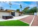 Relaxing backyard with hot tub, shaded patio, artificial turf, and bocce ball court at 3597 Cochise Ln, Las Vegas, NV 89169