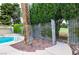 The inground pool is next to a lush green privacy hedge, offering shade and a sense of seclusion at 3597 Cochise Ln, Las Vegas, NV 89169